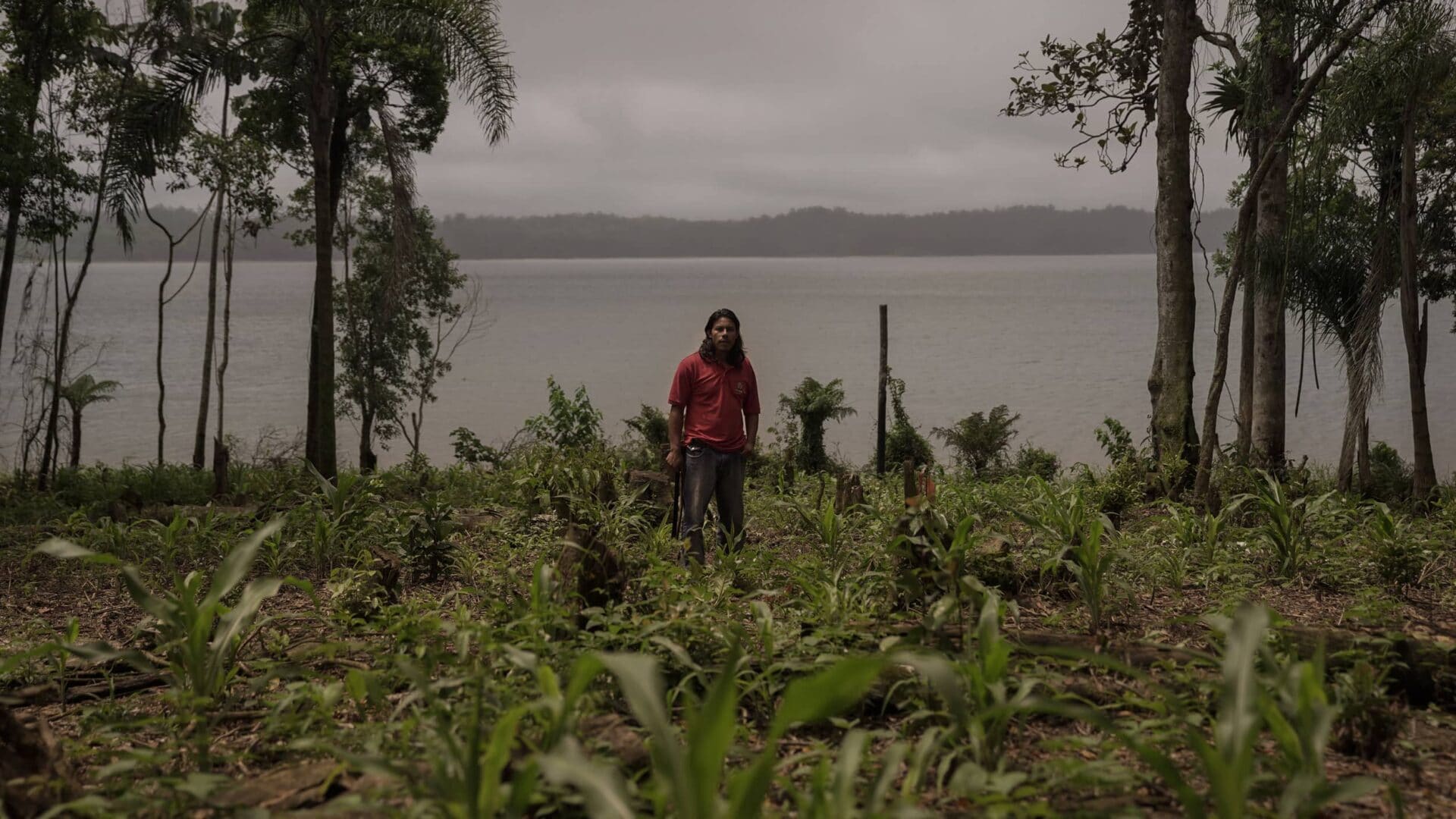 Homem Guarani posa com rio ao fundo